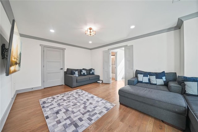 living room featuring ornamental molding and wood-type flooring