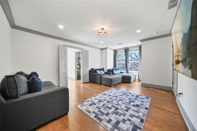 bedroom featuring hardwood / wood-style flooring, ceiling fan, and crown molding