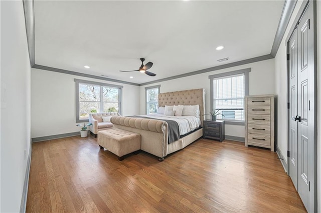 bedroom with crown molding, ceiling fan, and hardwood / wood-style flooring