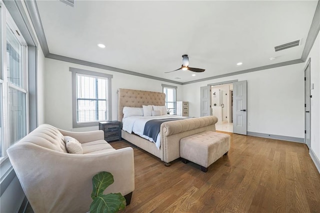 bedroom with crown molding, wood-type flooring, and ceiling fan