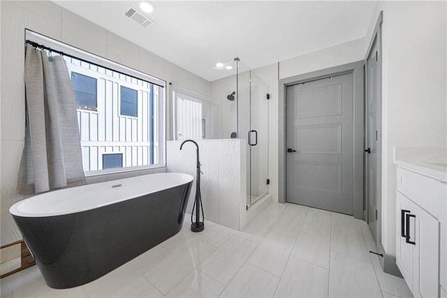 bathroom with vanity, separate shower and tub, and tile patterned flooring