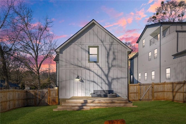 rear view of property with a lawn