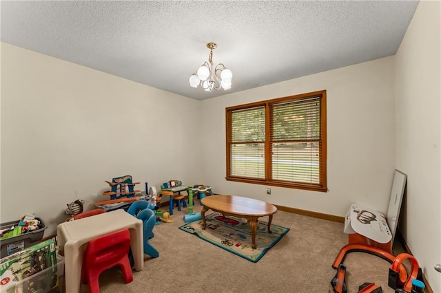 game room with carpet, a chandelier, and a textured ceiling