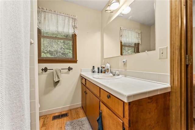 bathroom featuring vanity and hardwood / wood-style flooring