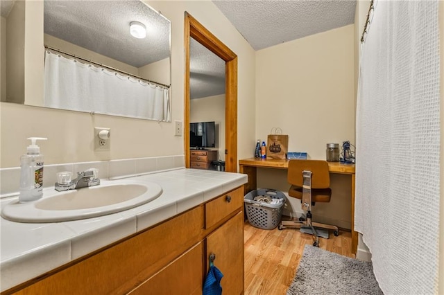 bathroom featuring vanity, a textured ceiling, and hardwood / wood-style floors