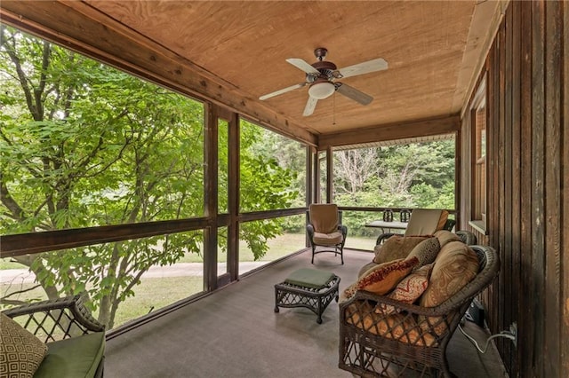 sunroom with wood ceiling, a wealth of natural light, and ceiling fan