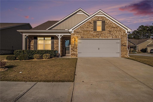 view of front of home with a garage and a yard