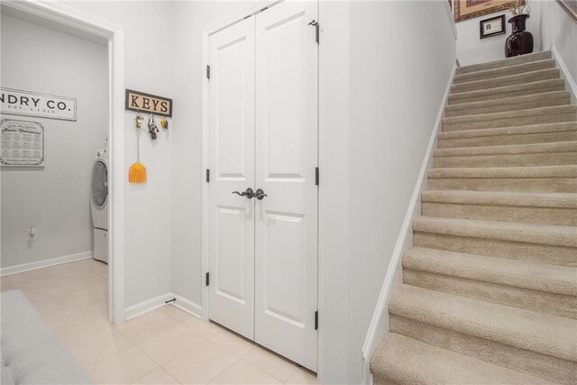 stairs featuring washer / clothes dryer