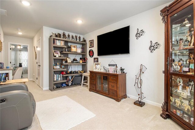 living room with ceiling fan and light colored carpet