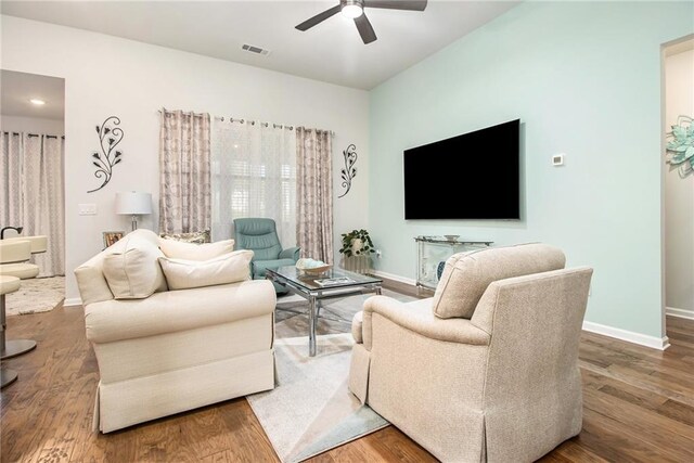 living room featuring hardwood / wood-style flooring and ceiling fan