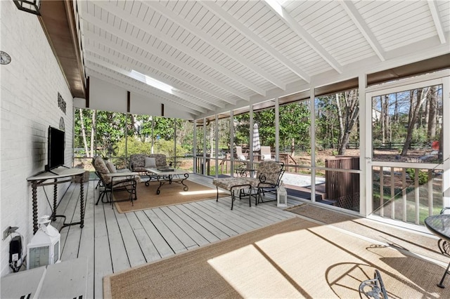 sunroom with vaulted ceiling with beams