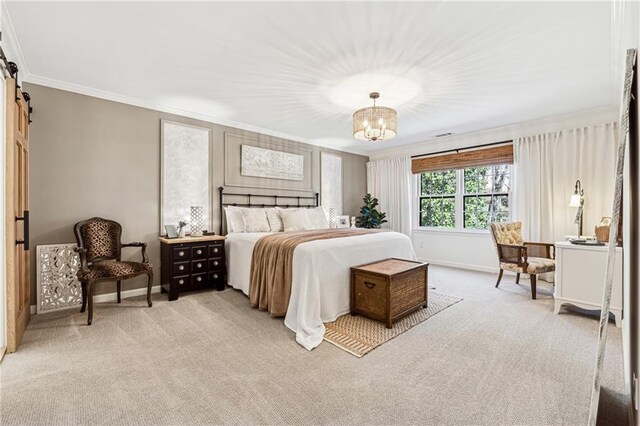 bedroom with light carpet, crown molding, baseboards, and a barn door