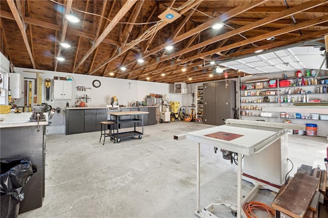 interior space with a garage, concrete flooring, and a workshop area