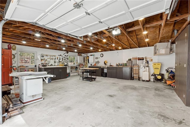 garage with a workshop area and a garage door opener