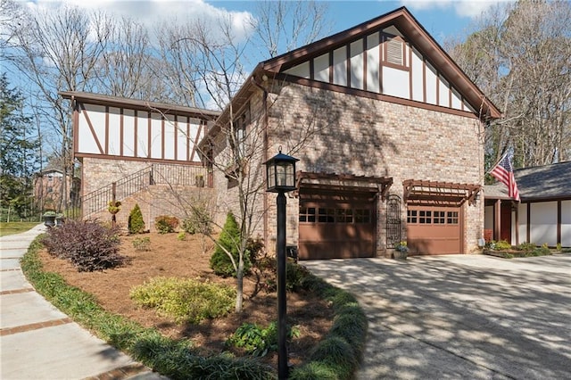 view of front of property featuring concrete driveway, brick siding, an attached garage, and stairs