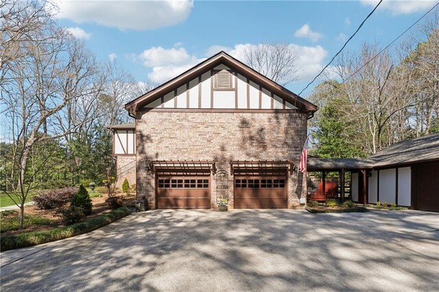 view of home's exterior with a garage, driveway, and brick siding