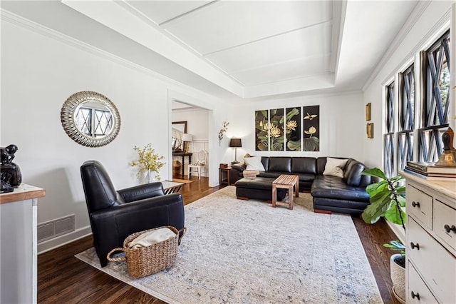 living area with dark wood-style flooring, a raised ceiling, visible vents, and baseboards