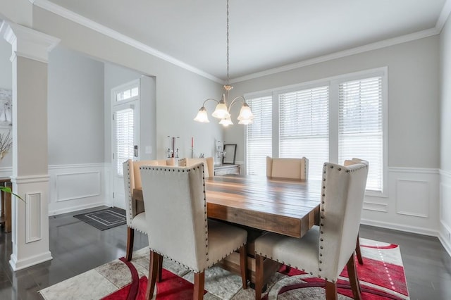 dining room featuring dark hardwood / wood-style flooring, ornamental molding, plenty of natural light, and a chandelier