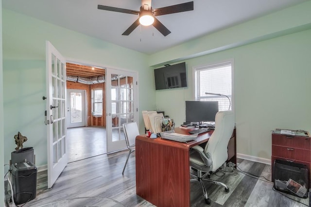 office with wood-type flooring, french doors, and ceiling fan