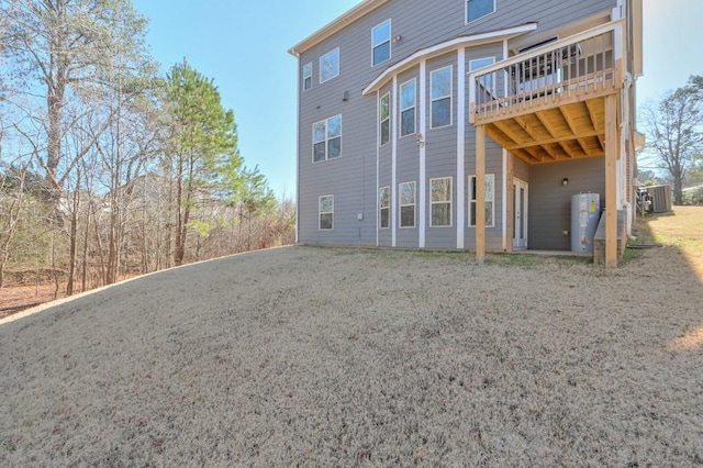 back of house with a deck and central AC unit