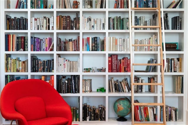 sitting room featuring wall of books