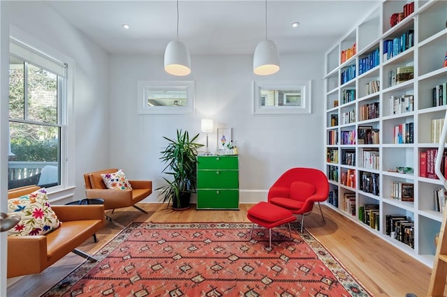 living area featuring recessed lighting, baseboards, and wood finished floors