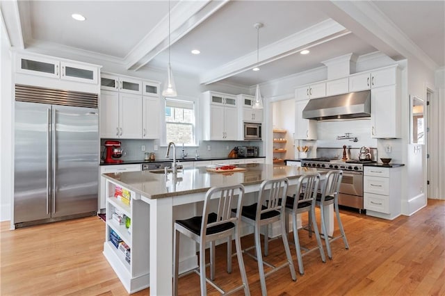 kitchen featuring open shelves, a sink, built in appliances, beamed ceiling, and exhaust hood