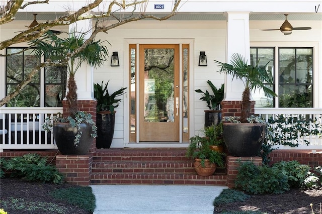 entrance to property with brick siding and a porch