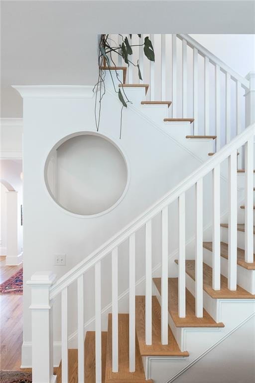 staircase featuring wood finished floors