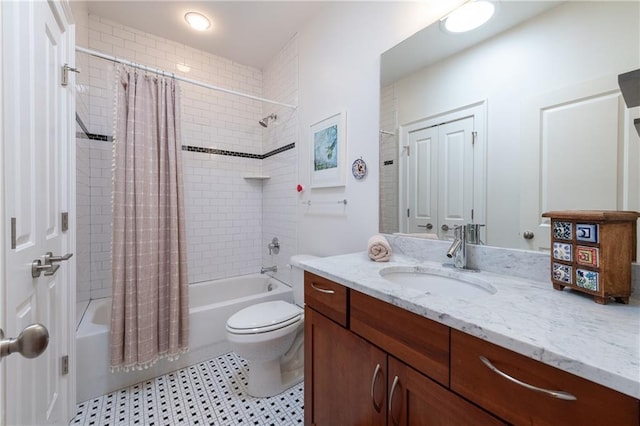 bathroom featuring toilet, shower / bath combo, and vanity