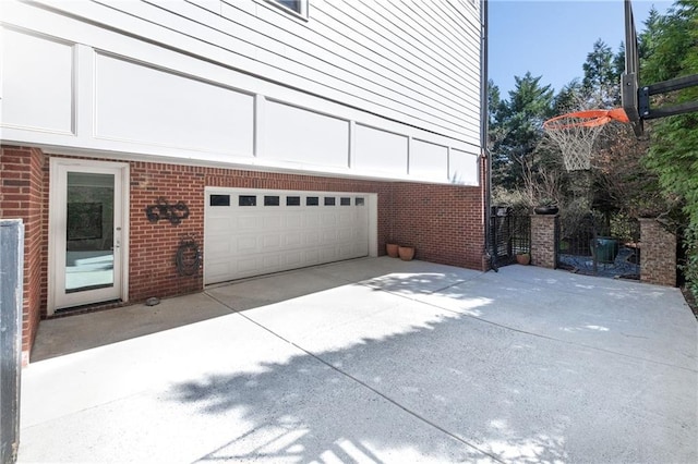 garage featuring concrete driveway