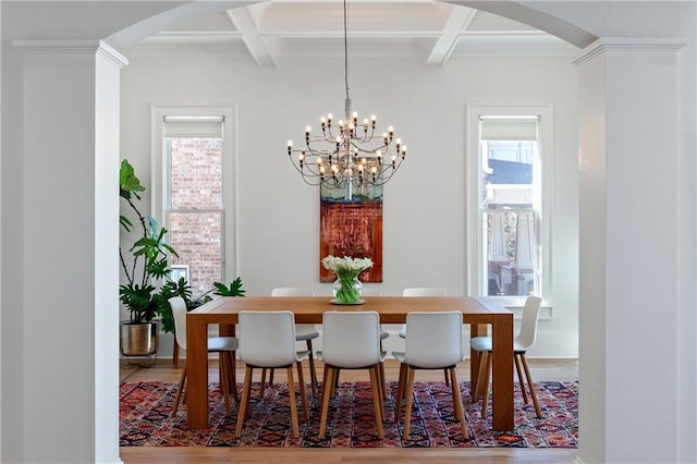 dining area featuring beamed ceiling, an inviting chandelier, wood finished floors, arched walkways, and coffered ceiling