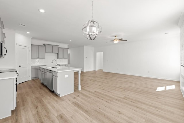 kitchen with a sink, stainless steel appliances, gray cabinets, and visible vents