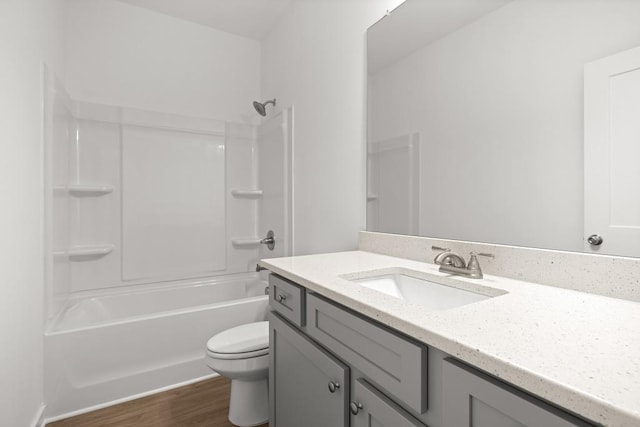 full bathroom with wood finished floors, vanity, toilet, and shower / bathing tub combination