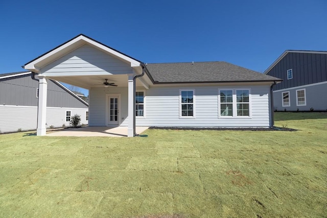 back of house featuring a patio area, ceiling fan, a shingled roof, and a yard