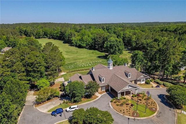 aerial view featuring a wooded view