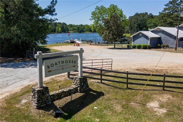 view of street featuring a water view and dirt driveway