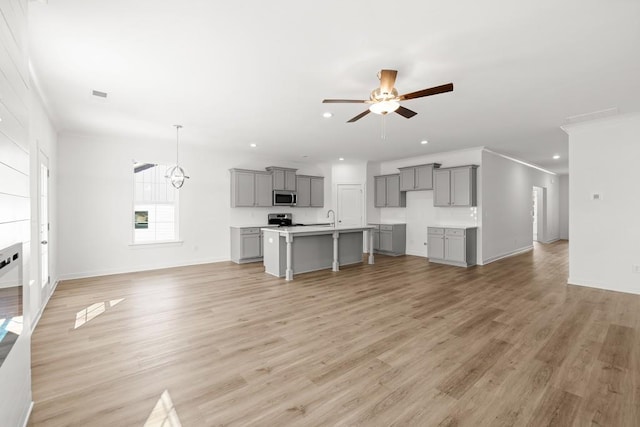 unfurnished living room featuring recessed lighting, ceiling fan, and light wood finished floors