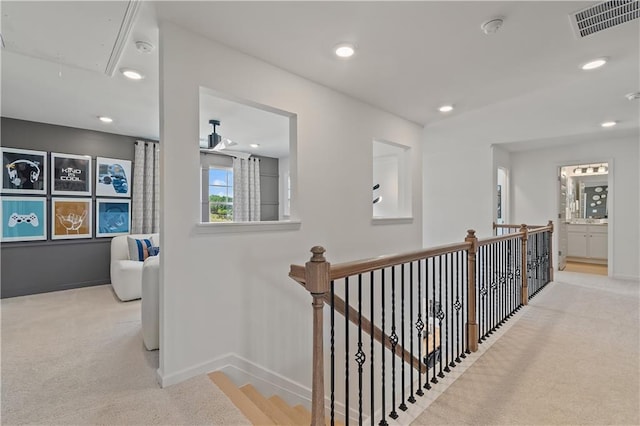 hallway featuring light colored carpet