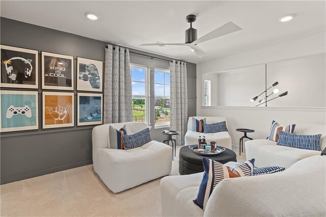 carpeted living room with ceiling fan with notable chandelier