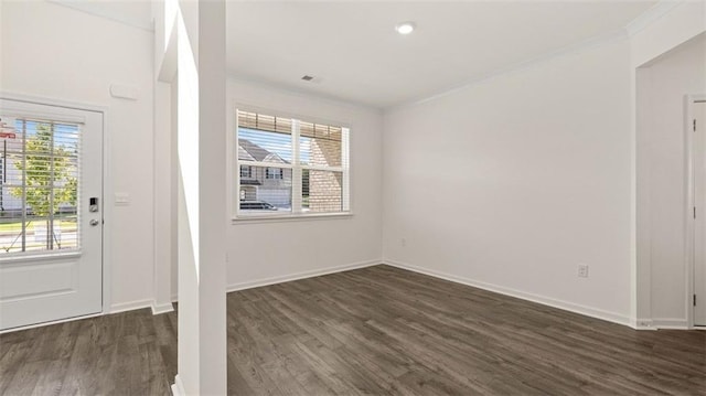 foyer featuring ornamental molding and dark wood-type flooring