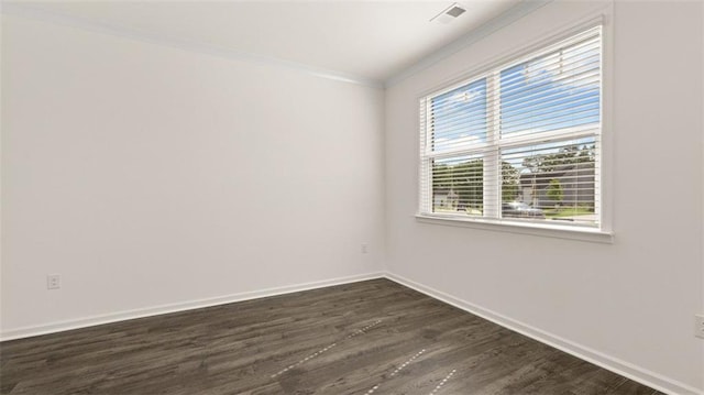 empty room with dark hardwood / wood-style flooring and crown molding