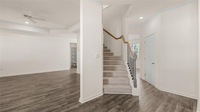 stairs featuring ceiling fan, hardwood / wood-style floors, and crown molding