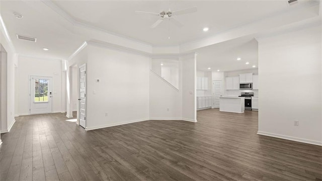 unfurnished living room featuring ceiling fan, dark hardwood / wood-style flooring, ornamental molding, and a tray ceiling