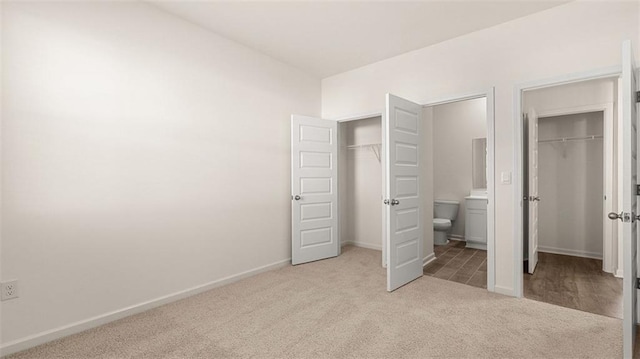 unfurnished bedroom with light carpet and ensuite bath