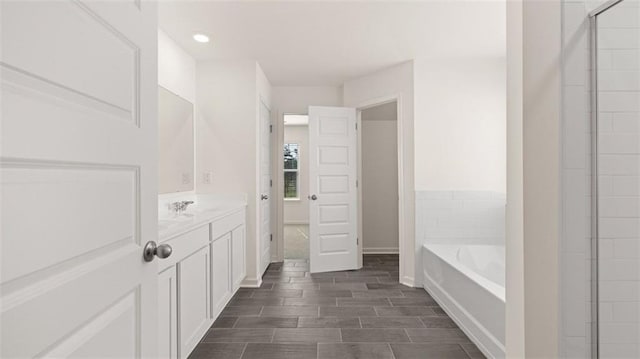 bathroom featuring vanity and a tub