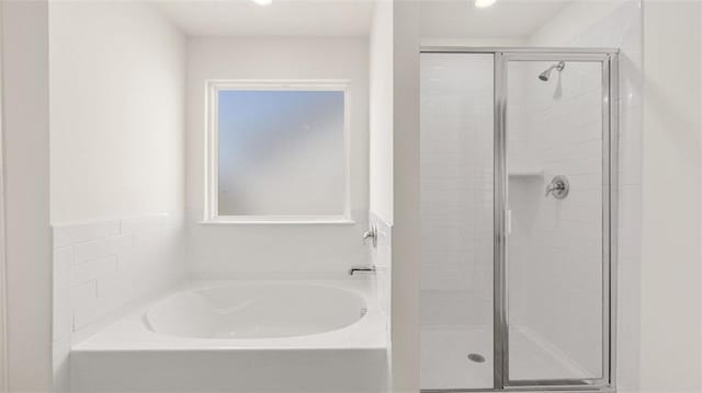 bathroom with separate shower and tub