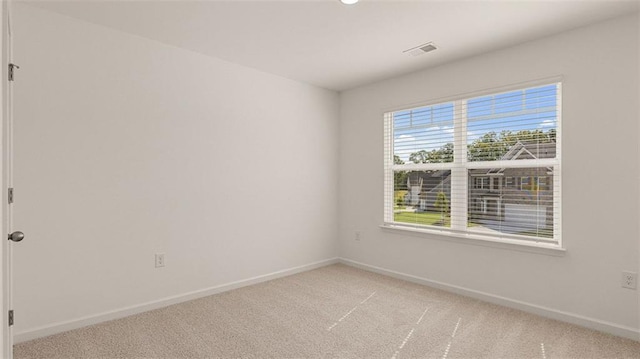 spare room with light colored carpet