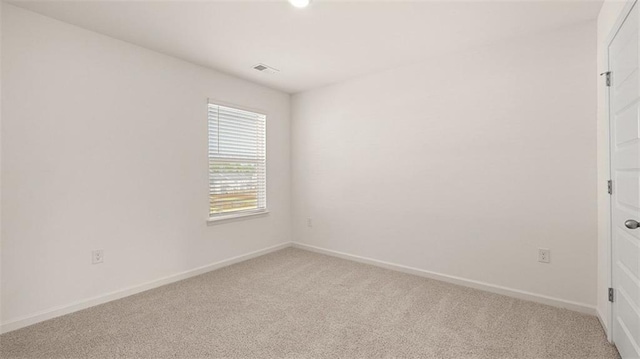 spare room with light colored carpet