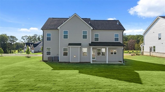 back of property with a lawn, a patio area, and central AC unit